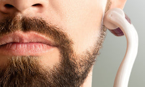 man-using-derma-roller-on-beard