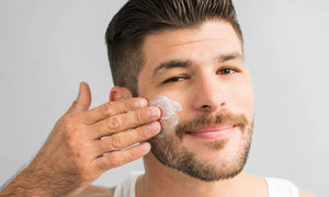 man-applying-cream-on-face-and-beard