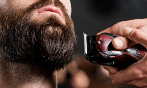 Woman-shaving-man-with-shaver